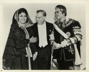 Soprano Leontyne Price, conductor Karl Bohm, and George Shirley posing during a production of Mozart's "Don Giovanni," 1966-67. Printed on front: "Louis Melancon, Metropolitan Opera, New York City."